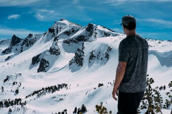 man looking at snow mountain