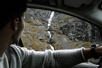 Man Looking at Waterfall
