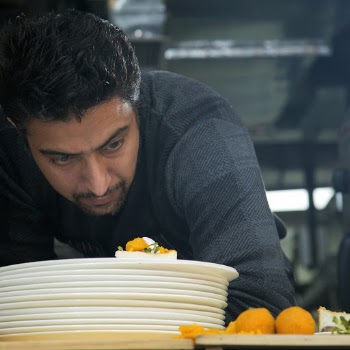 Man Looking Down at Plate of Food