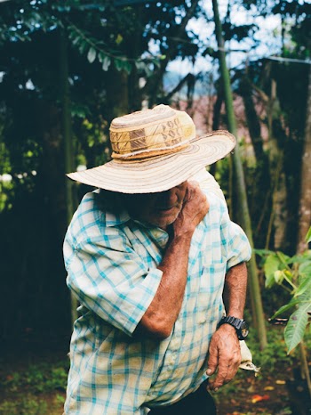 Man Looking Down Wearing Sunhat