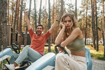 Man looking excited and the woman feeling upset after losing the competition