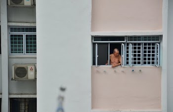 Man Looking Through Window