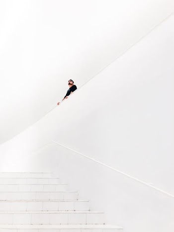 man looking up near stairs