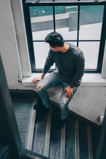 Man Looks Out Window