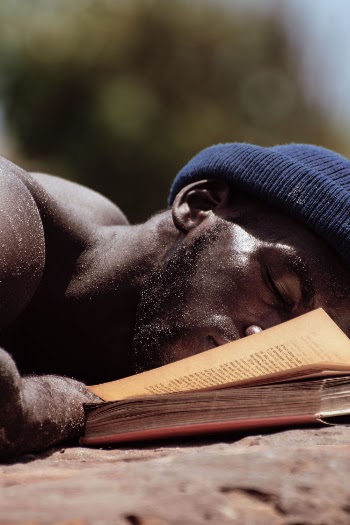 Man Lying Beside A Book