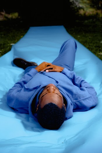 Man Lying Down On Blue Textile