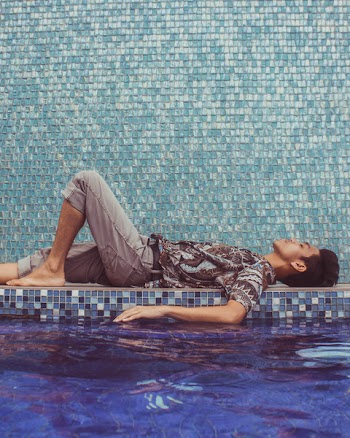 Man Lying Down on Pool Side