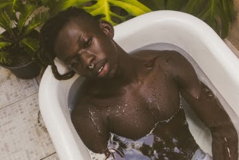 Man Lying in Bathtub Filled With Water