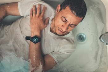 Man Lying on Bathtub Filled With Water