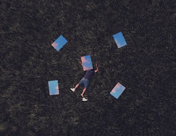 man lying on grass field