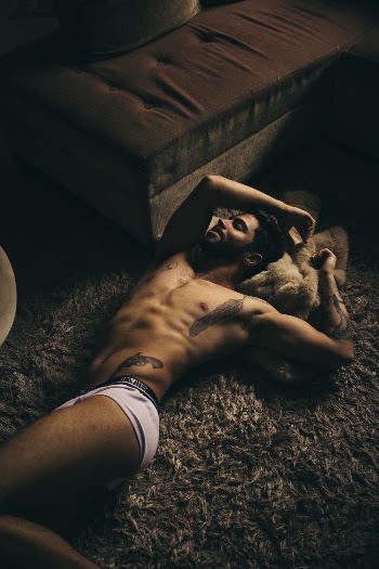 Man Lying on Gray Area Rug