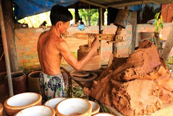 Man Molding Pot Using Clay
