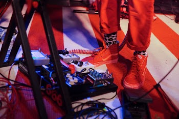 Man Near Guitar Pedal Controllers Near Keyboard Stand