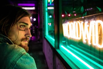 Man Near Neon Sign