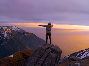 Man On A Cliff During Sunset
