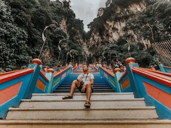 Man on a Staircase Going Towards Mountain