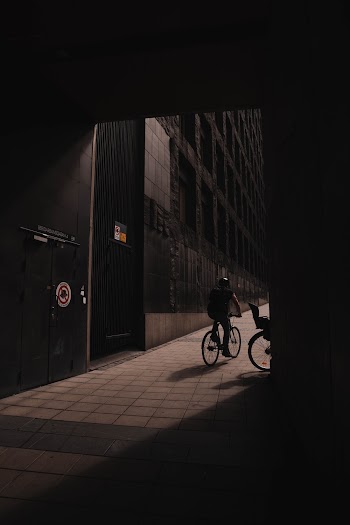 Man on Bike Near Building