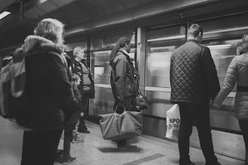 Man on Black Jacket Holding Woman on Brown Jacket