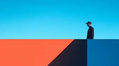 Man on Blue and Orange Wall Illustrating Self-Perception Spectrum Man on Blue and Orange Wall Illustrating Self-Perception Spectrum