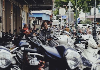 man on motor scooter smoking cigarette