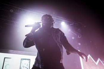 Man on Stage Holding Microphone