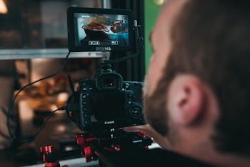 Man Operating Camera That Is Turned on