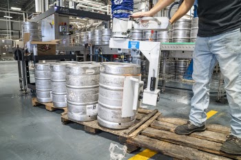 Man Operating Silver Machine for Silver Steel Kegs