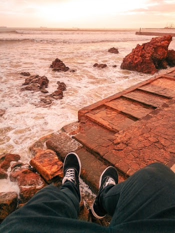 Man Overlooking the Sea during Golden Hour
