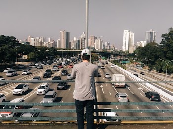 Man Overlooks Highway Bridge