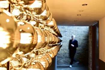 Man Passing Near Brown Brick Wall