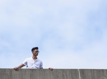 Man Peers Over Wall