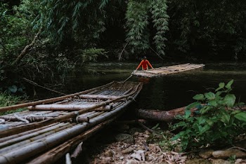Man Placing A Raft on Body of Water
