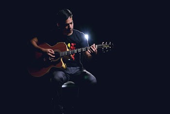 Man Playing a Guitar