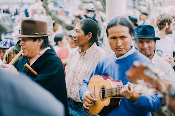Man Playing Acoustic Guitar Beside People during Daytime