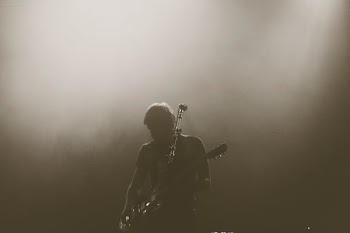 man playing electric guitar on stage