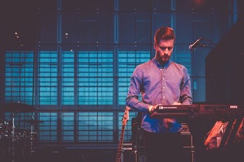 man playing electronic keyboard