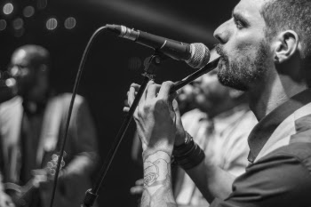 Man Playing Flute Near Microphone
