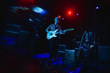 Man Playing Guitar at Stage