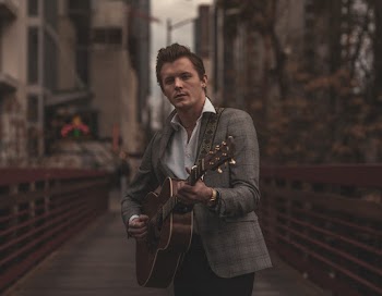 Man Playing Guitar on Pathway