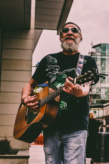 Man Playing Guitar on Street