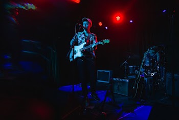 Man Playing Singing and Playing Guitar
