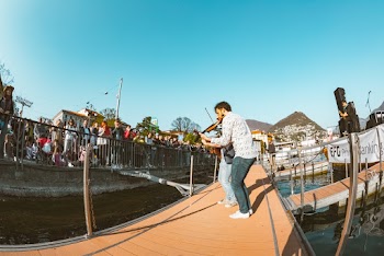 Man Playing Violin Surrounded With People
