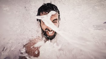 man playing water closeup photography