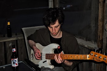 Man Playing White Electric Guitar