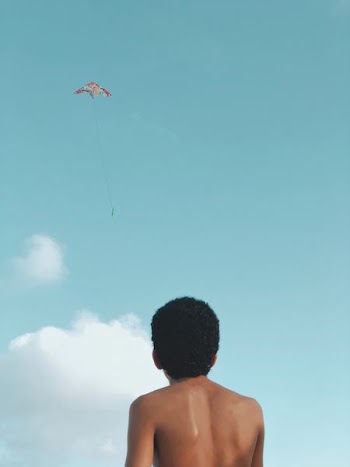 man playing with kite