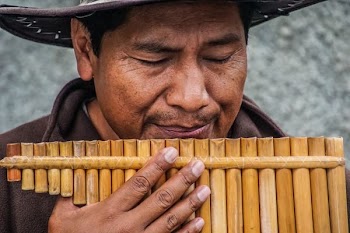 man playing wooden wind instrument