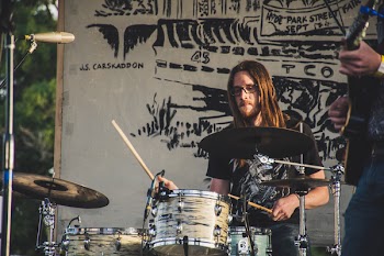 Man Plying Drums on Stage