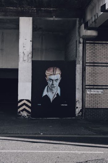 man portrait painting between wall