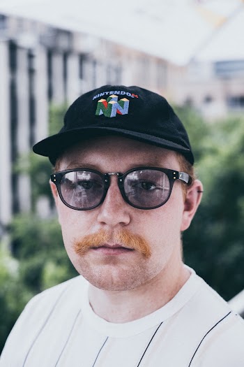 Man Portrait Wearing White Crew-neck Top and Black Cap