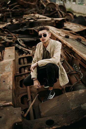 Man Posing By Junks